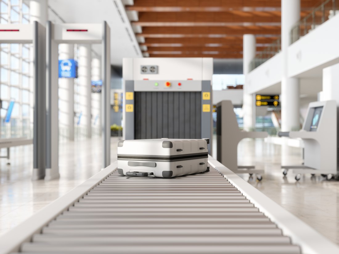 Airport security checkpoint X-ray scanner with cases on the belt