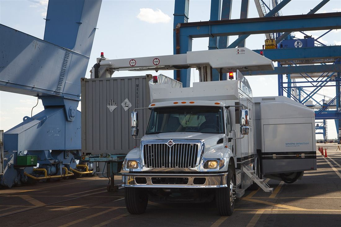 Mobile X-ray inspection unit scanning a shipping container at a port