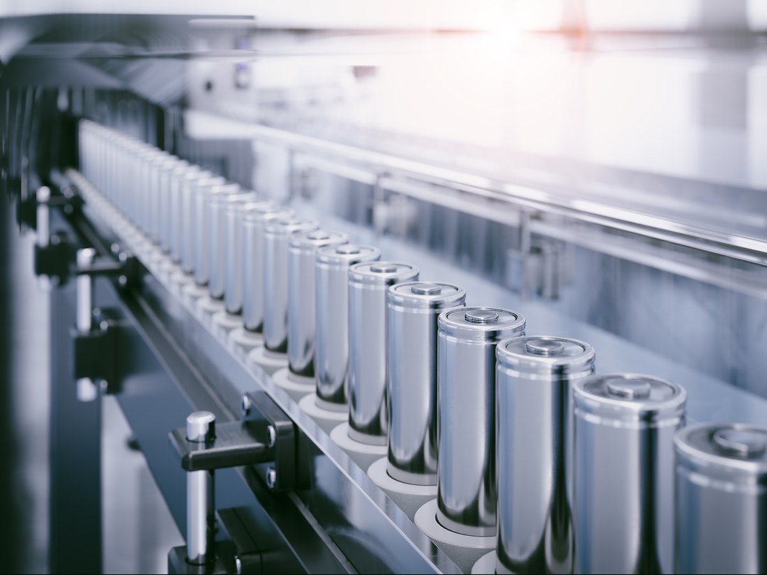 Cylindrical lithium cells on a production line conveyor